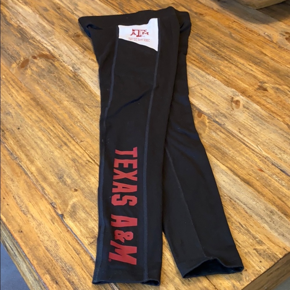 Pink official collegiate athletic leggings.